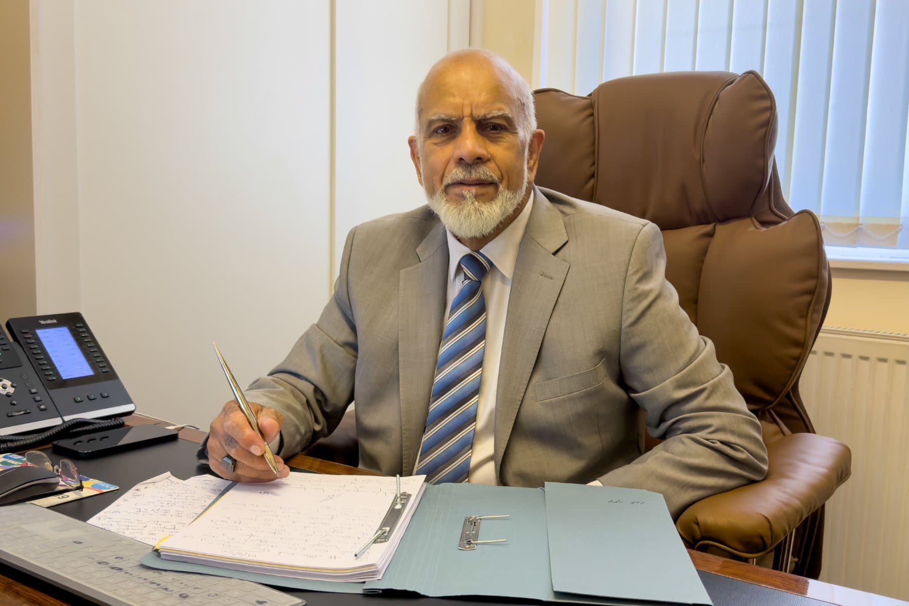 Akeel Miyan at their desk, Wimbledon Solicitors