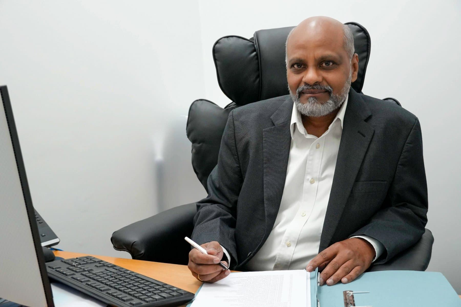 Vijay Payarda at their desk, Wimbledon Solicitors